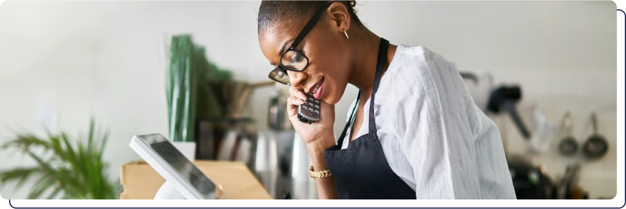 une femme qui est au téléphone et qui écrit