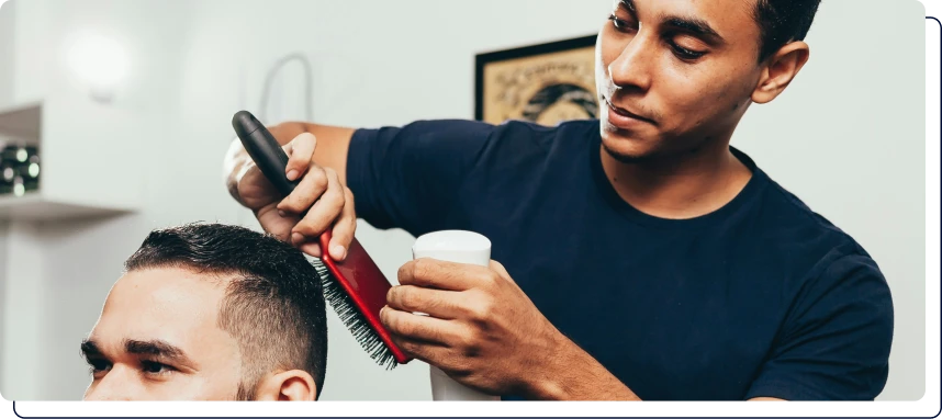 un coiffeur qui coupe les cheveux d'un homme